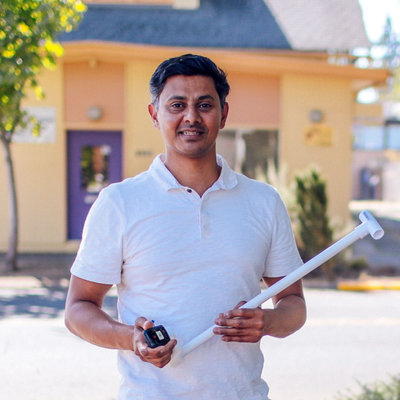 Prof. Vivek Shandas holds a thermometer and data recorder used to measure urban heat