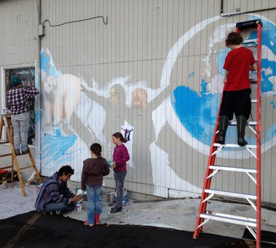 Students paint a climate change mural on Arriving by Bike. Photo Credit: Julia Olson.