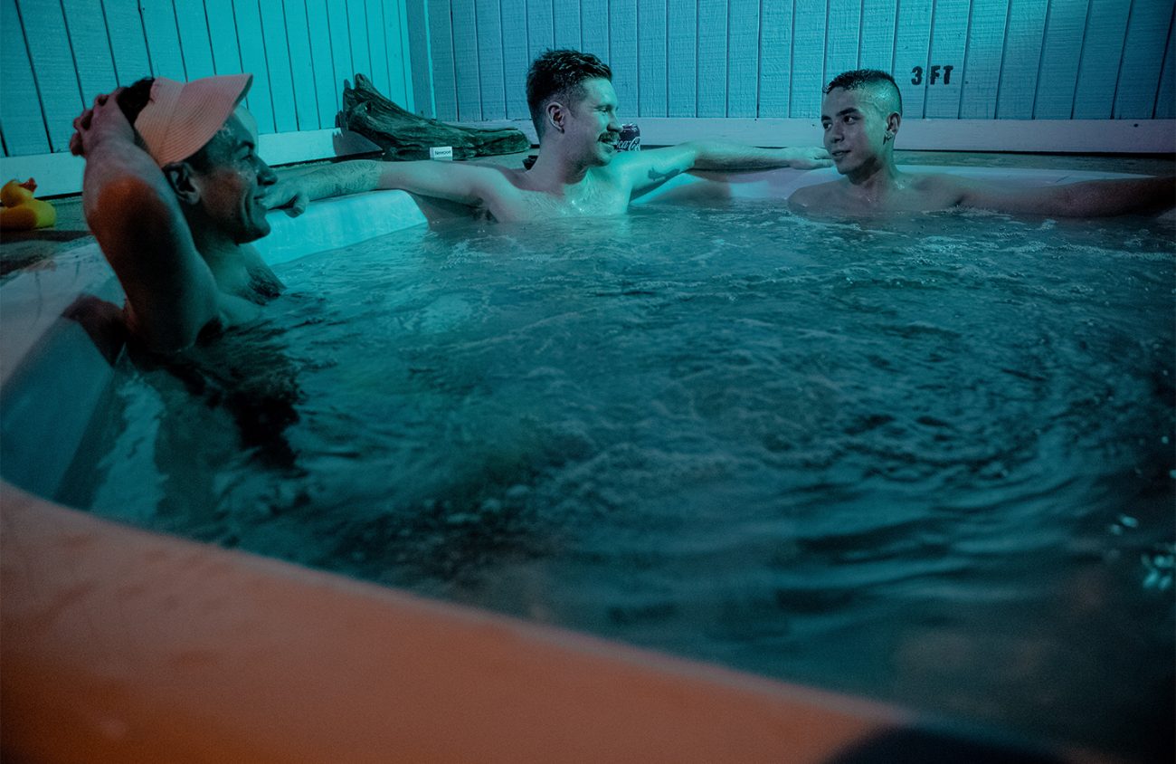 Photo of three men in a hot tub.