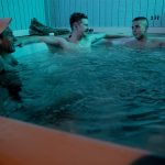 Photo of three men in a hot tub.