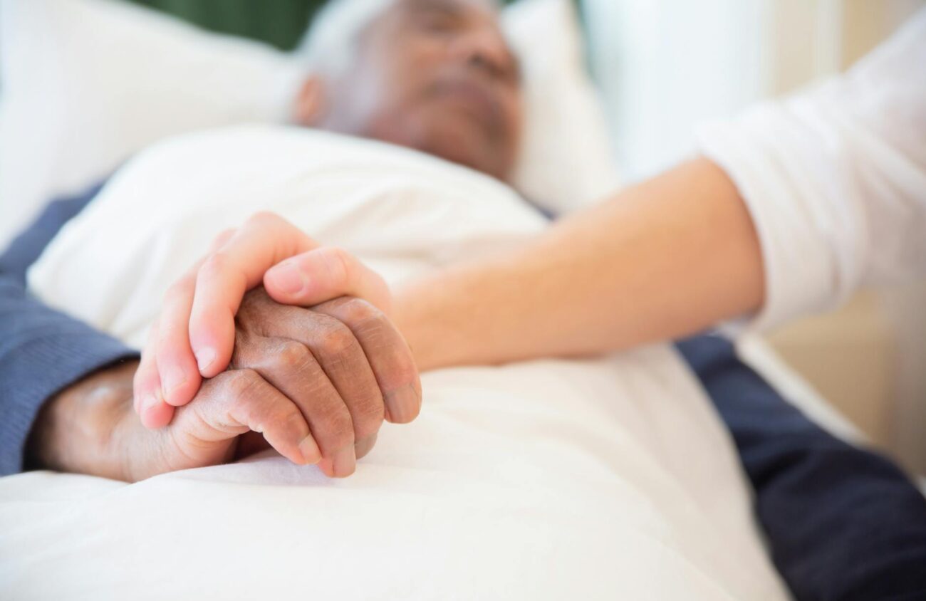 young persons hand holding an old persons hand