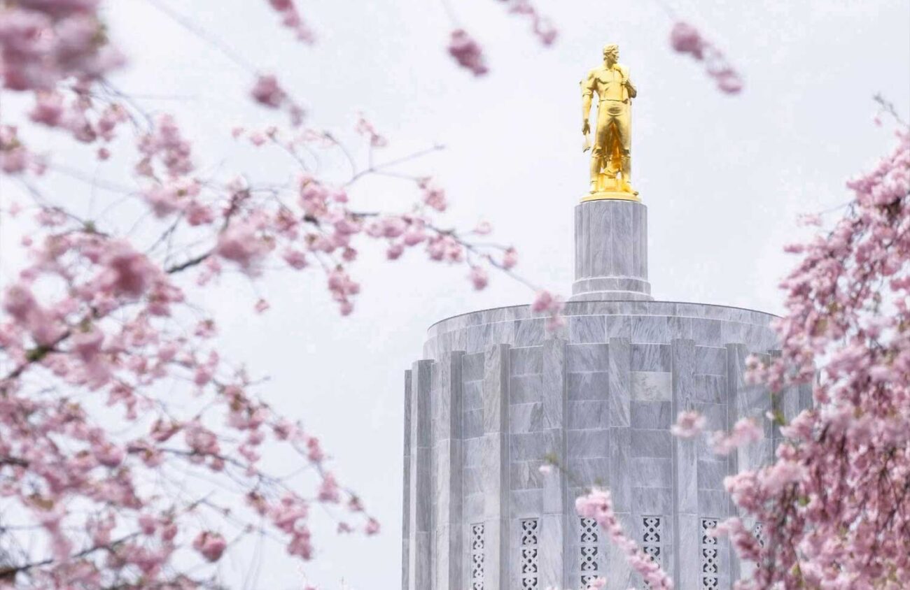 photo of gold statue on top of concrete building