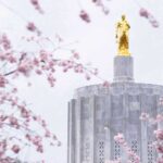 photo of gold statue on top of concrete building